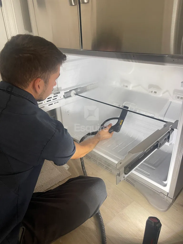 Open upright freezer interior showing frost on the rear panel