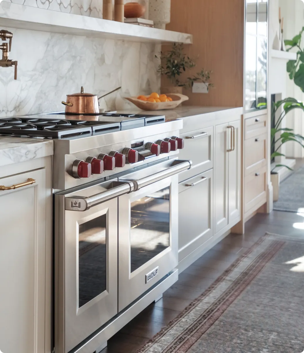 Wolf dual fuel range with red knobs in a residential Orange County kitchen